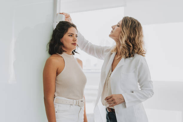 istock Woman measuring height at doctor's office 1498161152