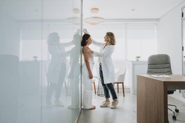 istock Woman measuring height at doctor's office 1498161177