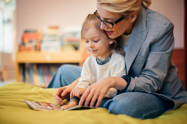 istock Happy Mother And Daughter Reading Book Together 1498161817