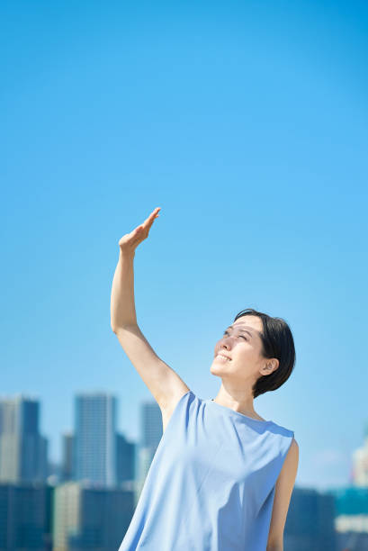 istock A woman blocking the strong sunlight under the blue sky 1498161826
