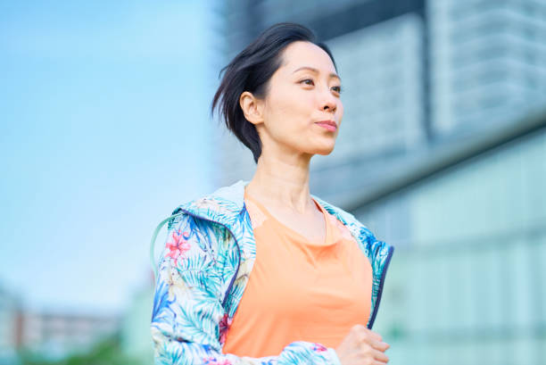 istock Woman running on urban green space 1498161896