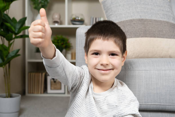 istock A 5-year-old boy shows his fingers up and smiles 1498163974