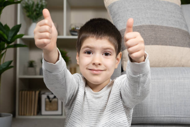 istock A 5-year-old boy shows his fingers up and smiles 1498163982