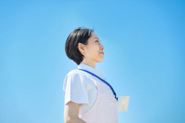 woman wearing white coat and apron outdoors