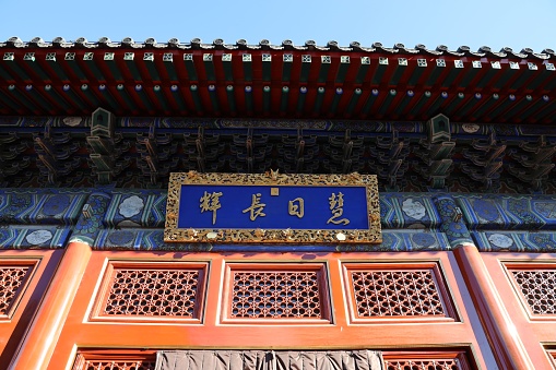 Beijing, China – February 01, 2023: The Beijing Wanshou Temple door with an ornate design and a sign featuring Chinese characters