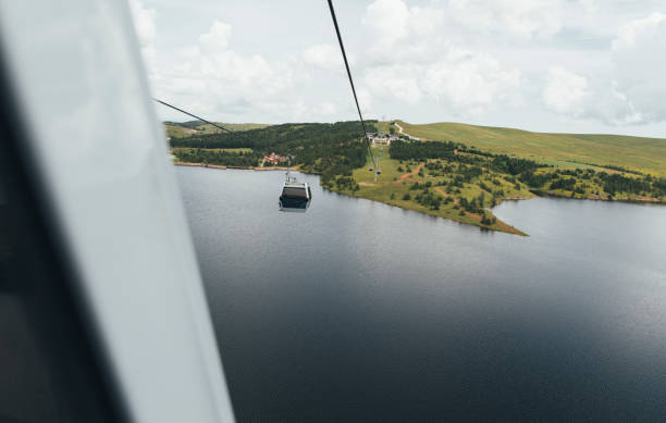 Mountain cable car: a captivating aerial view of Zlatibor mountain, Serbia from another gondola cabin.