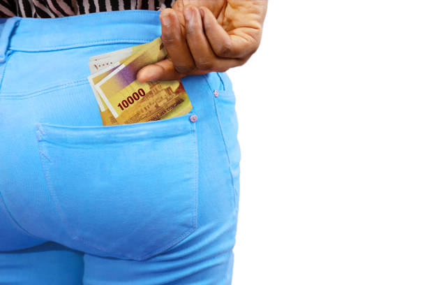 istock Black lady putting few Comorian franc notes into her back pocket. Removing money from pocket, hold money 1498166718