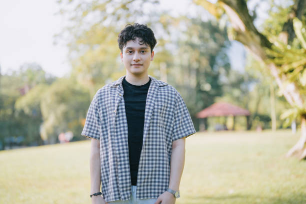 istock Japanese generation z young man looking at camera at public park 1498167034
