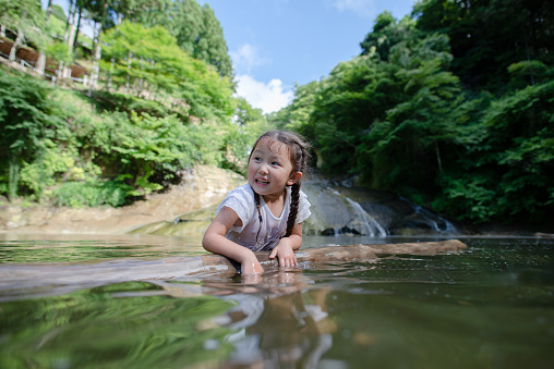 child playing in the stream