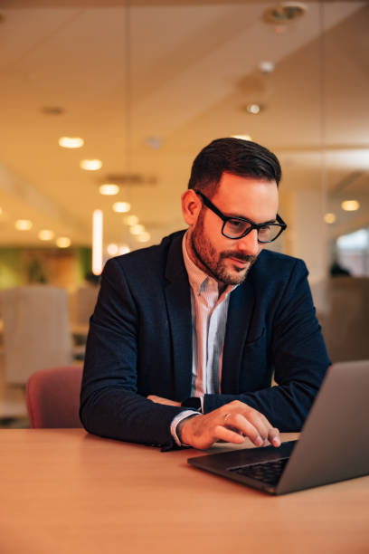 istock Serious businessman working over the laptop, sitting at the office, elegantly dressed. 1498171069