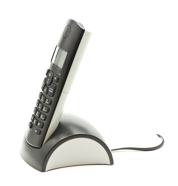 Cordless phone in cradle on white background.