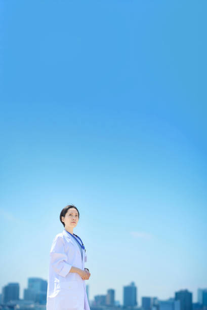 A woman in a white coat and a sunny skyline