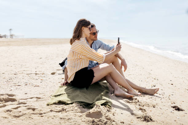 istock Couple taking a selfie on the beach 1498172042