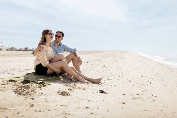 istock Man and woman having fun on the beach 1498172062