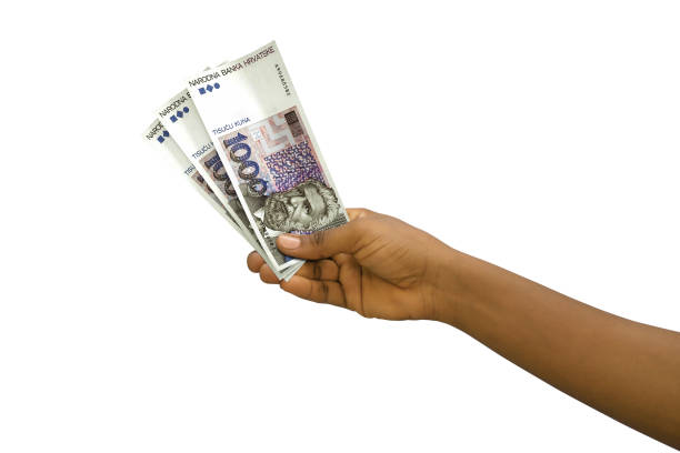 istock Fair hand holding 3D rendered 1000 Croatian Kuna notes isolated on white background 1498172130