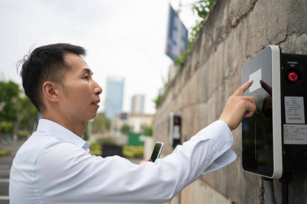 istock Man pays for car charging with mobile phone 1498172221