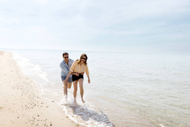 istock Funny couple enjoying on the beach 1498172265