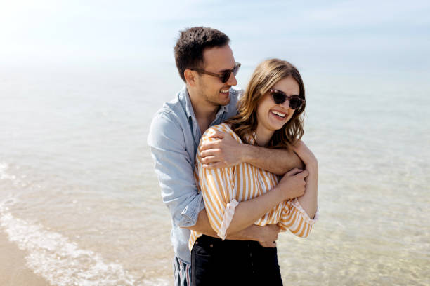 istock Smiling couple hugging on the beach 1498172287