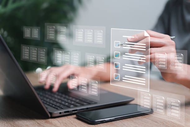 istock Document management and electronic checklist concept, Business women use a pen checklist on virtual screen Document Management System and process automation to efficiently document paperless operation 1498173296