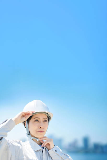 istock A woman wearing work clothes and checking a helmet 1498173923