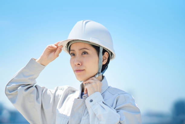 istock A woman wearing work clothes and checking a helmet 1498174090