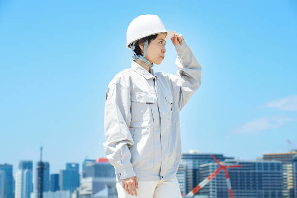 istock A woman wearing work clothes and checking a helmet 1498174273