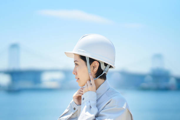 istock A woman wearing work clothes and checking a helmet 1498174598