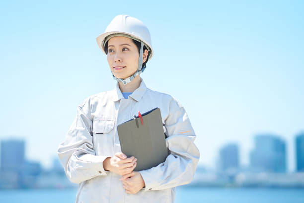 istock A woman wearing a helmet and wearing work clothes 1498174701