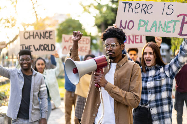 istock A young man leads the rally about climate change with his megaphone 1498174735