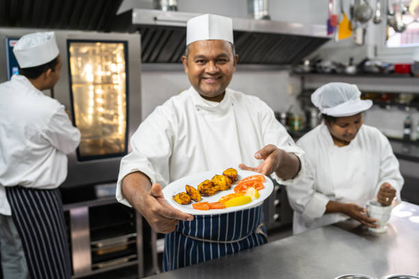 istock Chef displaying a plate of freshly cooked food 1498174747