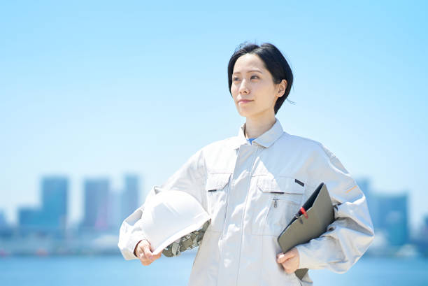 istock A woman in work clothes holding a helmet 1498176695