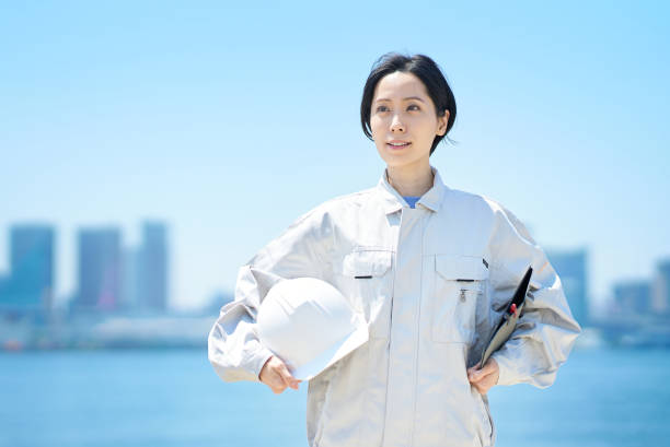istock A woman in work clothes holding a helmet 1498176776