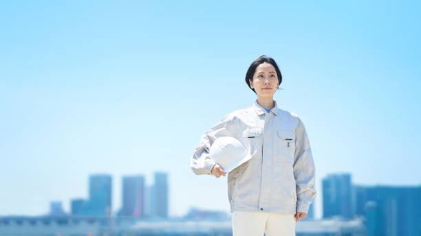 istock A woman in work clothes holding a helmet 1498177527