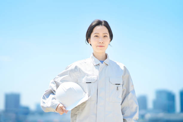 istock A woman in work clothes holding a helmet 1498177588