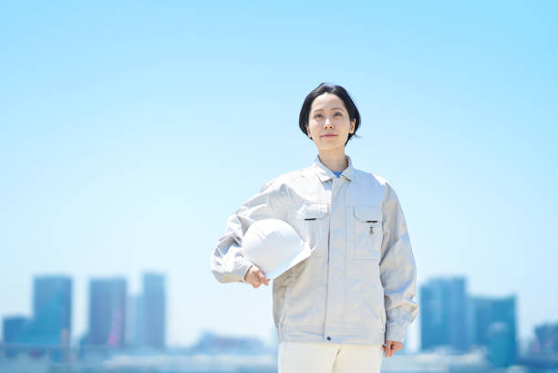 istock A woman in work clothes holding a helmet 1498177630