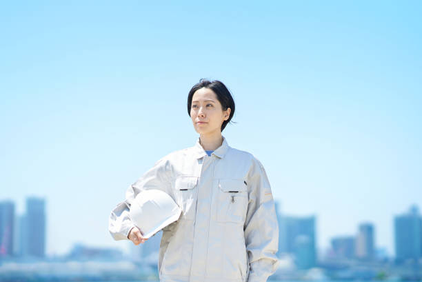 istock A woman in work clothes holding a helmet 1498177754