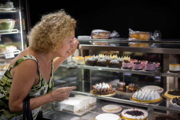 istock Senior woman at a bakery store 1498178832