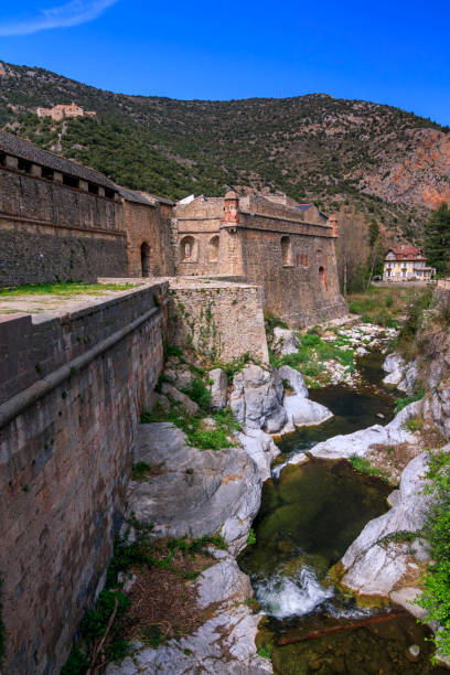 The ramparts of Villefranche de Conflent The views of fortifiet village of Villefranche de Conflent and river in a sunny day with blue sky. villefranche de conflent stock pictures, royalty-free photos & images