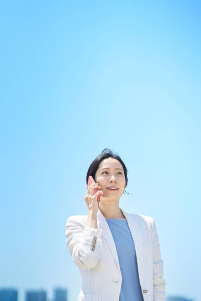 business woman talking on smartphone on fine day