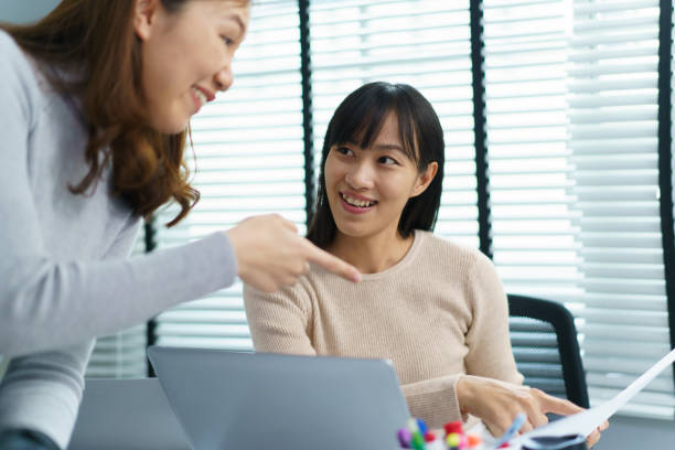 istock Asian women drinking and discussing together in office. 1498181858