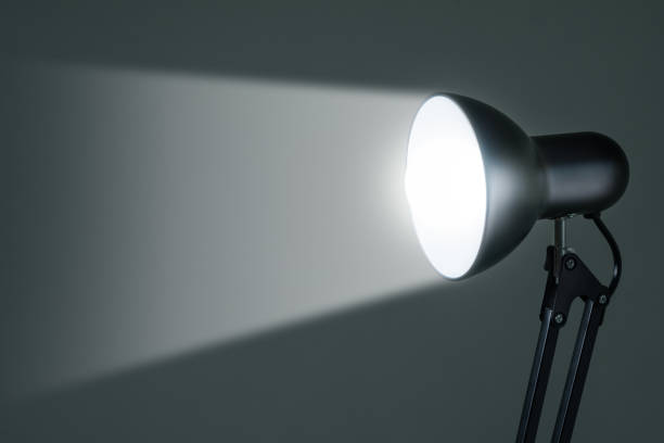 istock lighting retro desk lamp with light beam, highlight space for text or as a background 1498182954