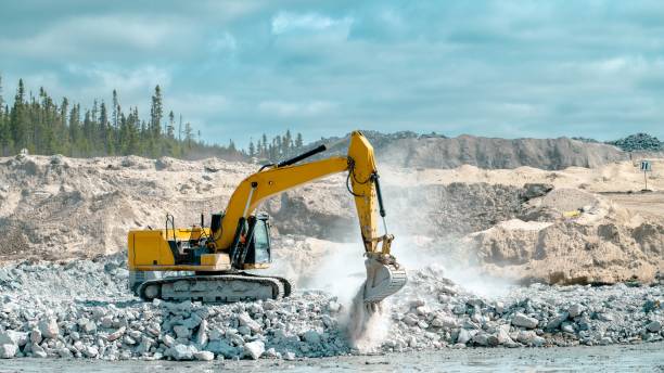 istock Yellow excavator placing stones 1498183010