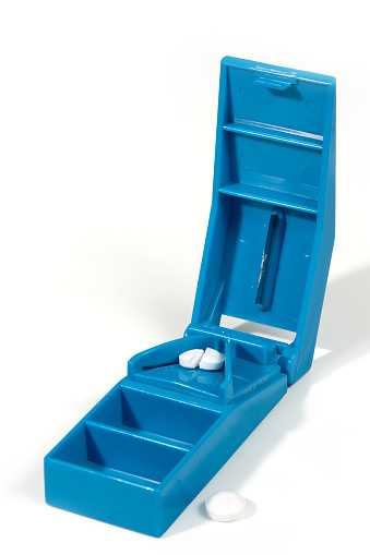 Pill cutter with tables. With clipping paths for cutter, tablet and hole in lid