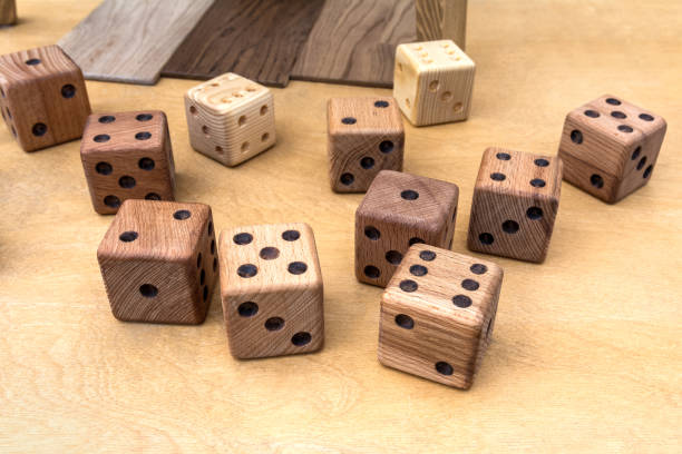 istock Homemade wooden dice are lying on the table 1498192862