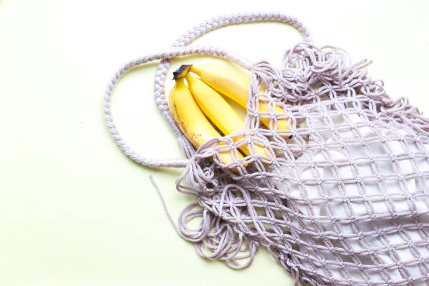 istock Flat lay ecology. Bananas in an eco bag.  Mesh bag 1498192990