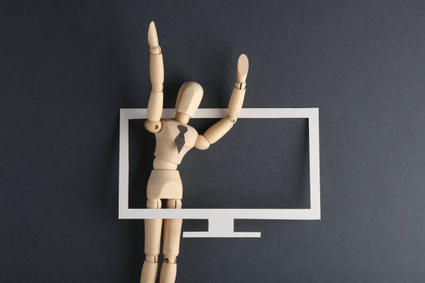 istock Propaganda. Wooden puppet broadcasts from TV 1498193210