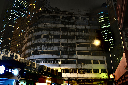 Old Tor Po Mansion residential building by night in Quarry Bay, Hong Kong island.