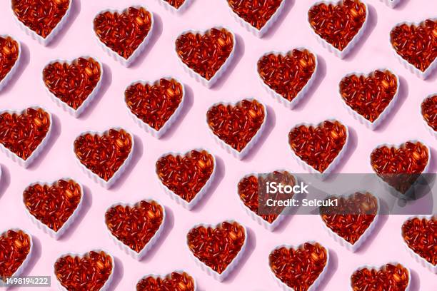 Omega 3 Fish Oil Capsules In A Heartshaped Plate On Pink Background Stock Photo - Download Image Now