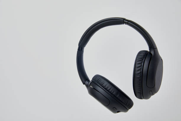 istock Black Wireless Headphones Floating in Studio - Stock Photos. 1498194879