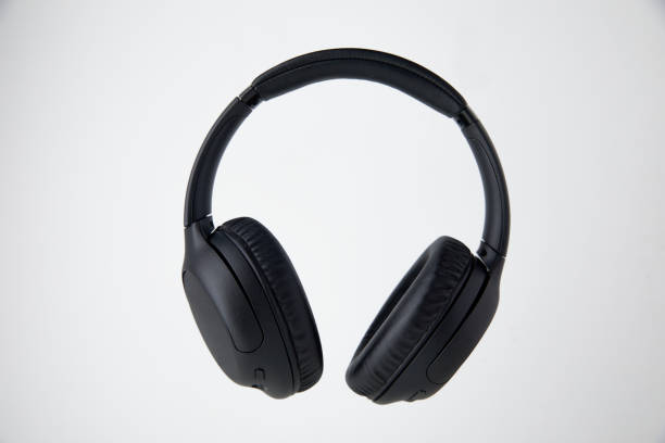 istock Black Wireless Headphones Floating in Studio - Stock Photos. 1498194926